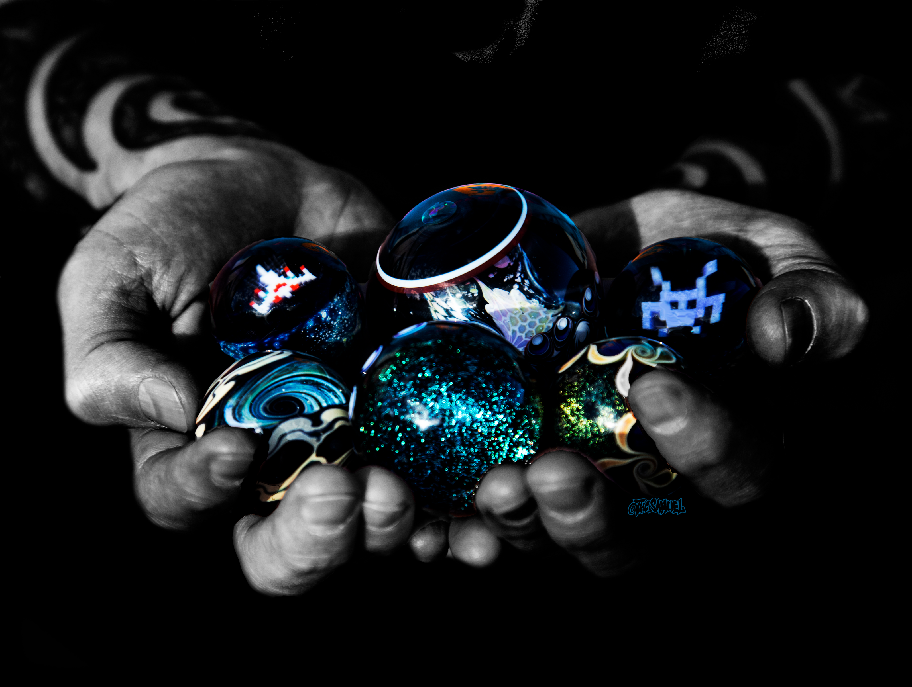 Hands full of glass marbles